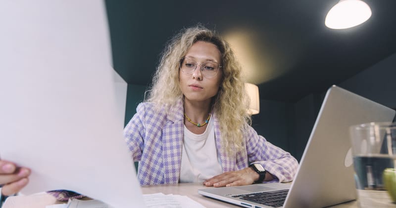 Woman with Curly Hair Holding Papers