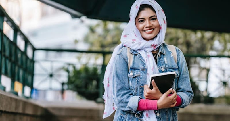 Student Smiling with Notebook